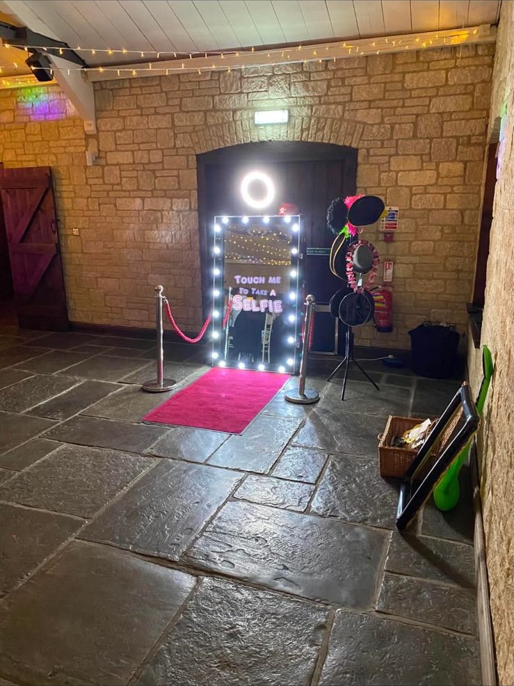 Magic Mirror in a rustic barn with stone walls and a red carpet